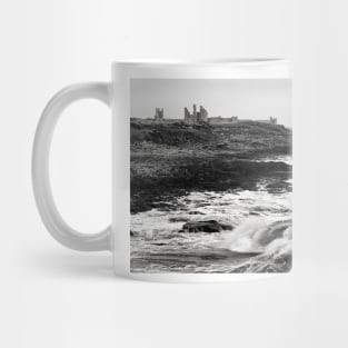 Rough waves hit the rocks near Dunstanburgh castle in Northumberland, UK Mug